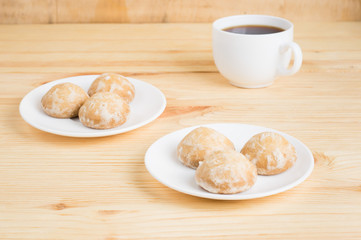 gingerbread on plates and black coffee on a wooden background. breakfast or snack