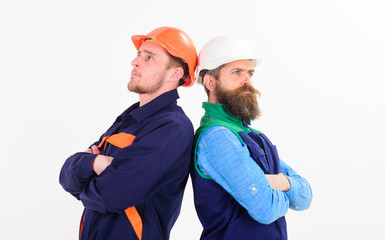 Pensive young men builders, engineers in hard hat,