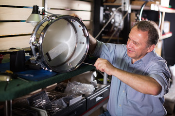 Man is repairing drum