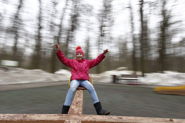 Child is riding a carousel