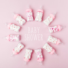 Decorative Baby milk bottles with candy. Decorations for Baby shower party. Flat lay, top view