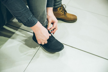 man seek new sneakers in store. shopping concept. shoes fashion buy shopping