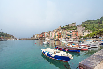 Fototapeta na wymiar The magical landscape of the harbor with colorful houses in the boats in Porto Venere, Italy, Liguria