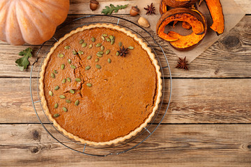 Pumpkin homemade pie on wooden background. top view