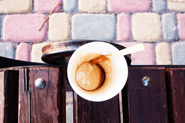 Empty cup of espresso on a wooden bench. Candid.
