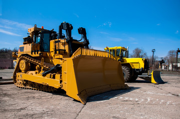 New crawler bulldozer on the assembly site of the workshop.