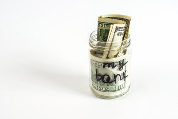 My bank written on a jar with dollar banknotes. Savings and Home finances concept