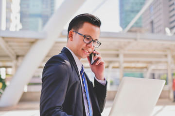 Business Concept Communication, Young businessman is playing mobile.