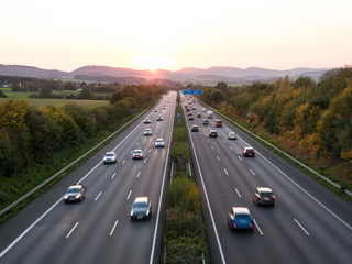 The road traffic on a motorway at sunset