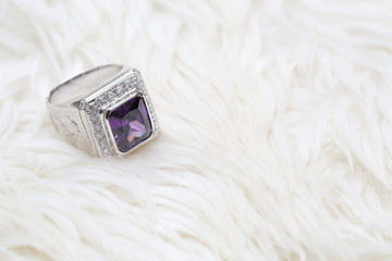 purple gemstone on diamond ring