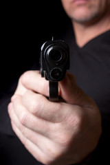 A firearm in the hands of a man defending or attacking