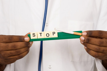 doctor holding a cigarette and a stop message