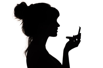 silhouette of woman admiring herself in a mirror, profile of a woman face, concept of fashion and...