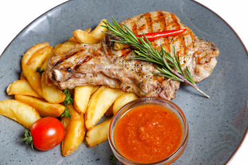 fried meat with garnish of potatoes isolated on white background