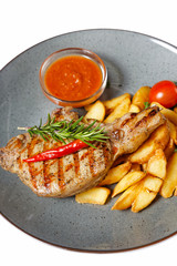 fried meat with garnish of potatoes isolated on white background