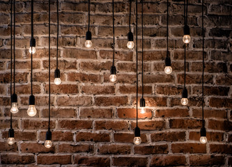 Incandescent bulbs on brick wall background in loft style