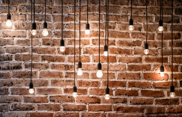 Incandescent bulbs on brick wall background in loft style