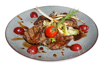 grilled meat on bone with garnish of vegetables