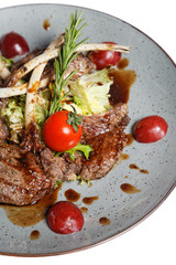 grilled meat on bone with garnish of vegetables