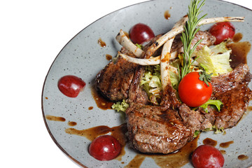 grilled meat on bone with garnish of vegetables