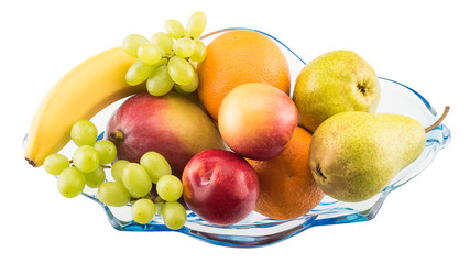 Various colorful fruits in a glass vase isolated on white background, top view