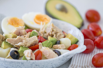 Potaoes, tuna, avocado, hard-boiled egg salad.