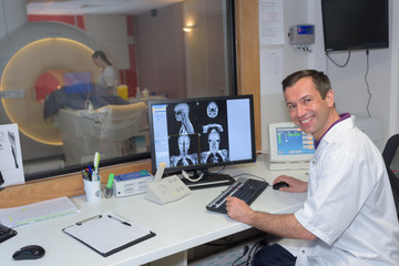 Portrait of male medical worker programming mri scanner