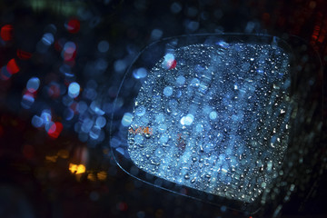 rain and traffic in side view mirror