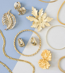 Woman's Jewelry. Vintage jewelry background. Beautiful gold tone brooches, braceletes, necklaces...