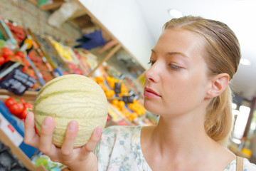 Woman selecting a melon