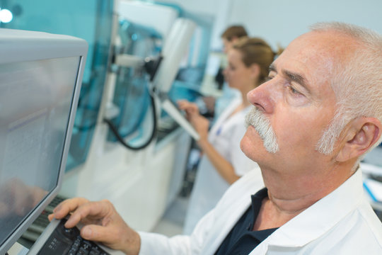senior male researcher carrying out scientific research in a lab
