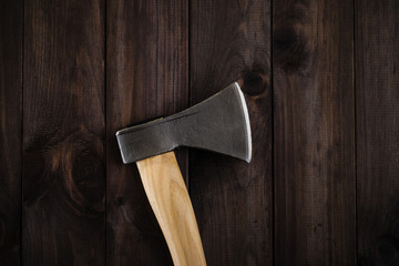 Closeup lumberjack axe on dark wooden background