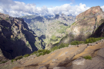 Pico do Arieiro hiking trail, amazing magic landscape with incredible views, rocks and mist, view of the valley between rocks
