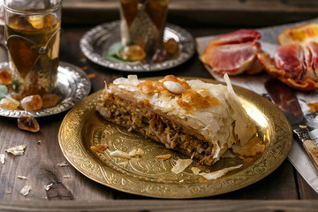 Close view of bastilla pie on copper plate