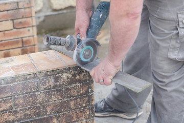 tiler cutting a tile with a grinder