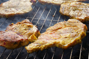 Grilled meat on barbecue.