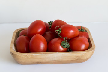 tomato isolated. tomatoes in the wooden box on the white background.