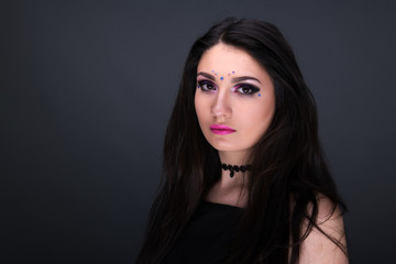 Fototapeta premium Close up face. Young arabic woman in black sexy dress, isolated on gray background
