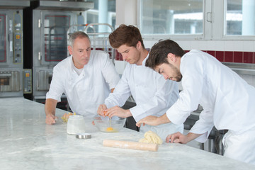 male baker and his assistants