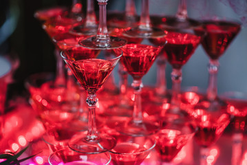 glasses with Martini cocktail on a tower of red color