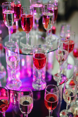 wine and champagne glasses in the bar of the restaurant for the holiday with color illumination for the new year celebration
