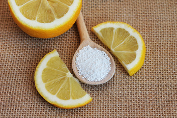 Top view of citric acid in a wooden spoon