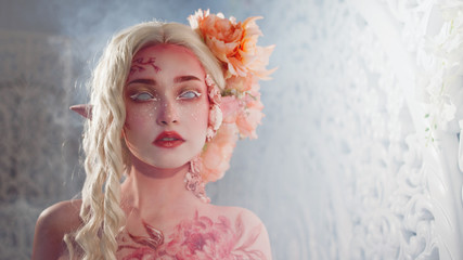 Mysterious elf girl. Creative pink makeup. Elvish ears.
