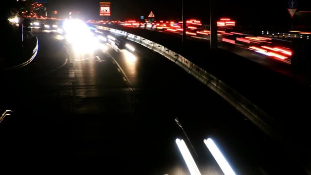 Highway Traffic Cars at Night Time Lapse. Highway with heavy traffic at rush hour. Lots of traffic at night. Cars driving at high speed.