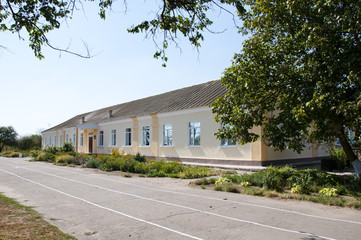 ukrainian village school with summer flowers and running road outdoor