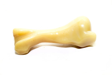 Yellow Fake bone for dogs on a white background