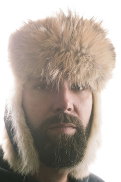 Close-up portrait of man wearing ushanka against clear sky