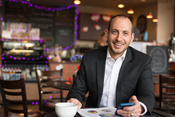 buisness man with coffee looking at camera