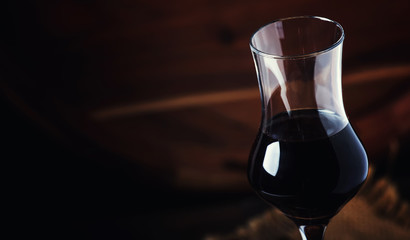 Coffee liqueur, vintage wooden background, selective focus