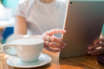 Fototapeta na wymiar Woman in Coffee Shop Using Technology